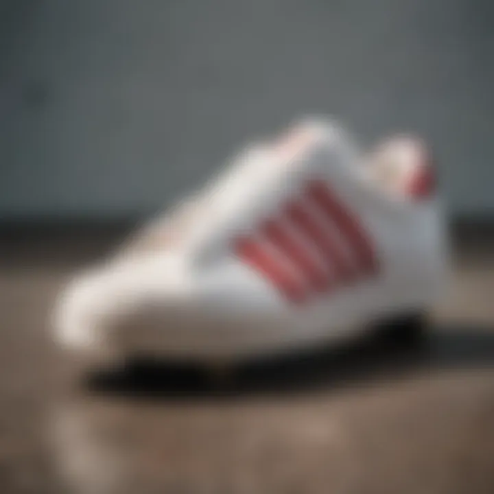 Adidas Shell Toe white with red stripes on a skateboard