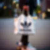 A skateboarder carrying an Adidas shopping bag showcasing its stylish design