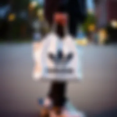 A skateboarder carrying an Adidas shopping bag showcasing its stylish design