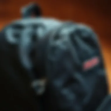 Close-up of the design features of a black JanSport backpack highlighting its stitching and material