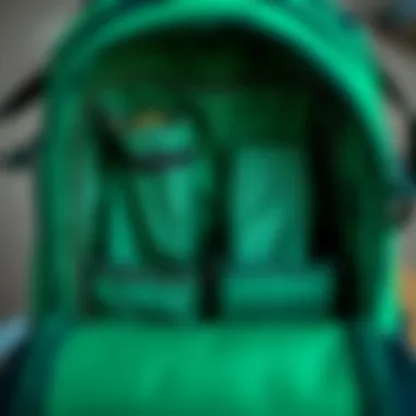 Interior compartments of the Dakine Green Backpack showing storage capabilities