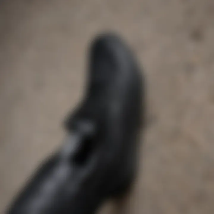 Close-up of black Vans on a textured surface