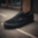 Detailed view of black Vans showcasing stitching and material quality