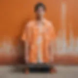 Vibrant orange and white tie dye shirt displayed against a skateboard backdrop