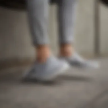 A stylish individual wearing grey checkered slip-on Vans