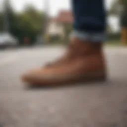 A pair of brown Vans sneakers resting on a skateboard.