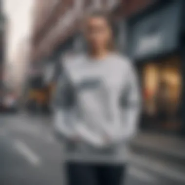 A model showcasing the grey Nike sweatshirt in an urban setting