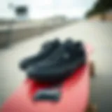 Black Vans shoes positioned on a skateboard deck