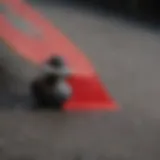 Close-up view of red grip tape on a skateboard deck