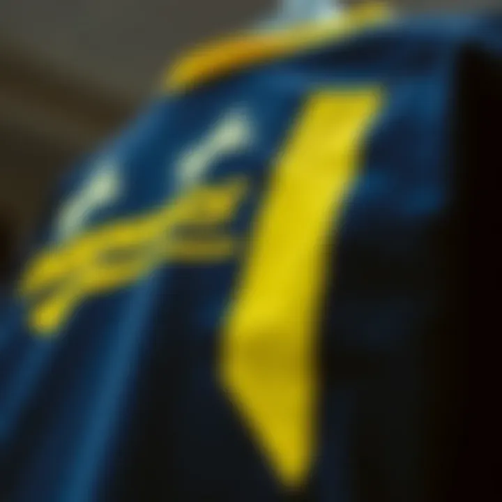 Close-up of graphic design on a navy blue tee with yellow accents
