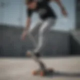 A skater showcasing low rise grey jeans while performing a trick on a skateboard.