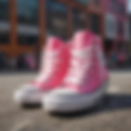 A pair of pink and white Converse Chuck Taylor shoes displayed against a vibrant urban backdrop.