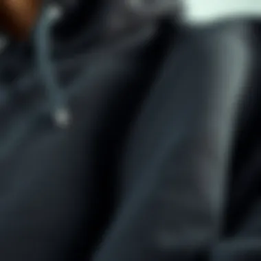 Close-up of the fabric and stitching of a black hood sweater, showcasing its quality and durability.