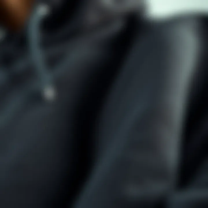 Close-up of the fabric and stitching of a black hood sweater, showcasing its quality and durability.