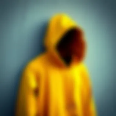 A close-up of a dark yellow hoodie hanging against a textured wall