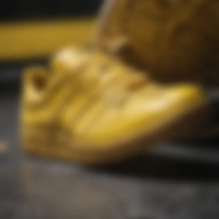 Close-up of yellow Adidas shoes highlighting design details.