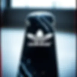 A black and white skateboard featuring the Adidas logo