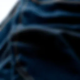 Close-up view of black blue jeans showcasing fabric texture and stitching details