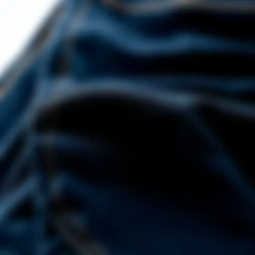 Close-up view of black blue jeans showcasing fabric texture and stitching details