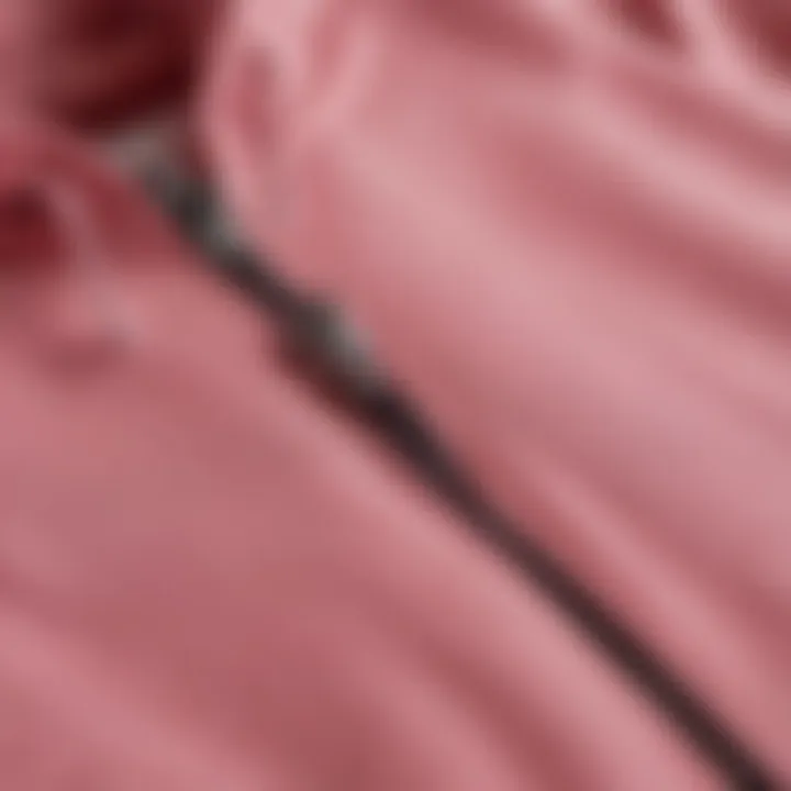 Close-up view of the material and stitching of the Pink Brand zip-up hoodie.