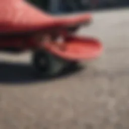 Close-up view of red Adilette slides on a skateboard