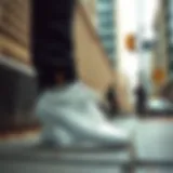 White Leather Vans in an Urban Setting Stylish white leather Vans low tops on urban pavement
